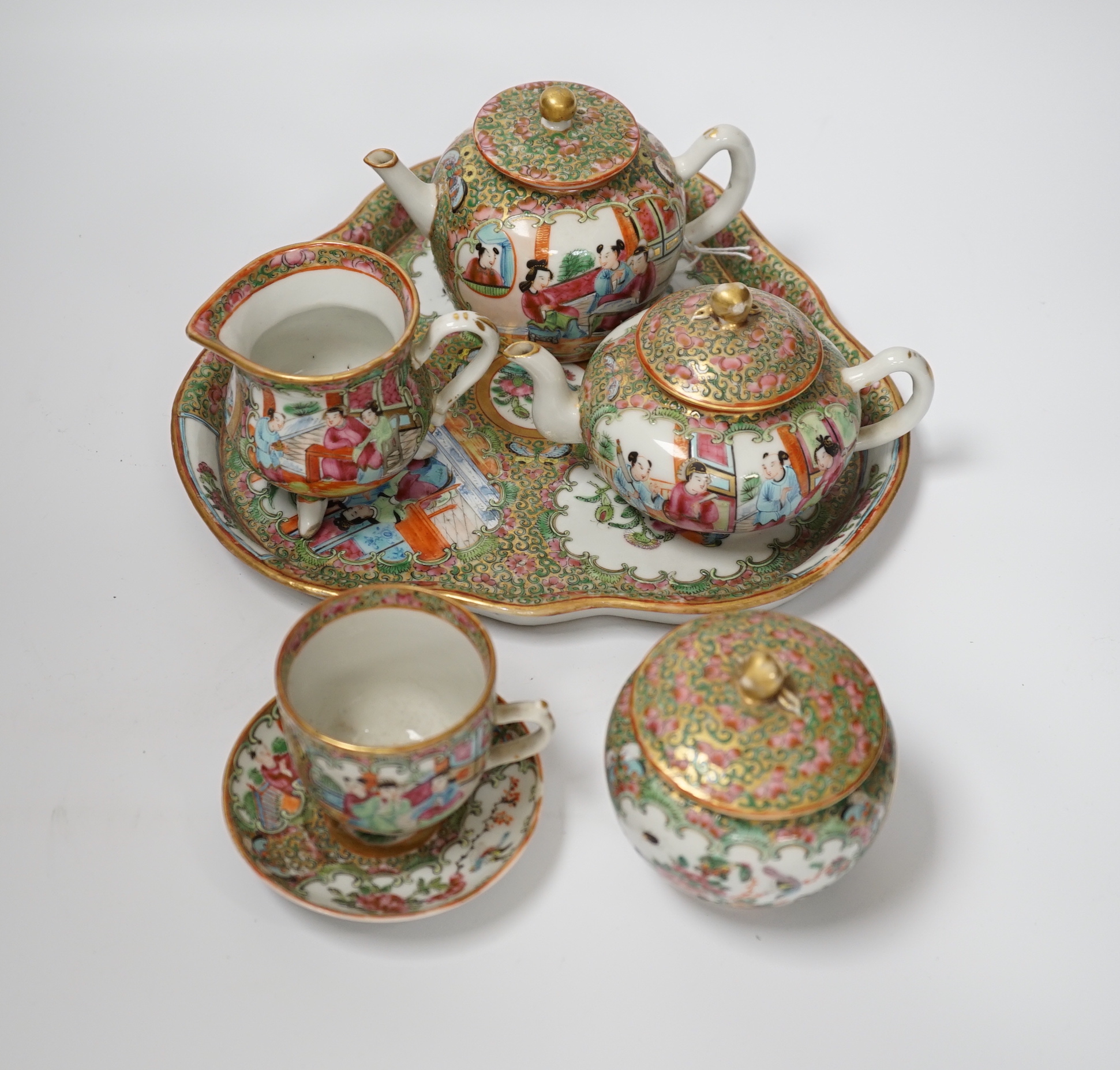 A 19th century Chinese famille rose teaset including a trefoil shaped tray, two teapots, sugar bowl, jug and cup with saucer, teapot 10cm high (6)